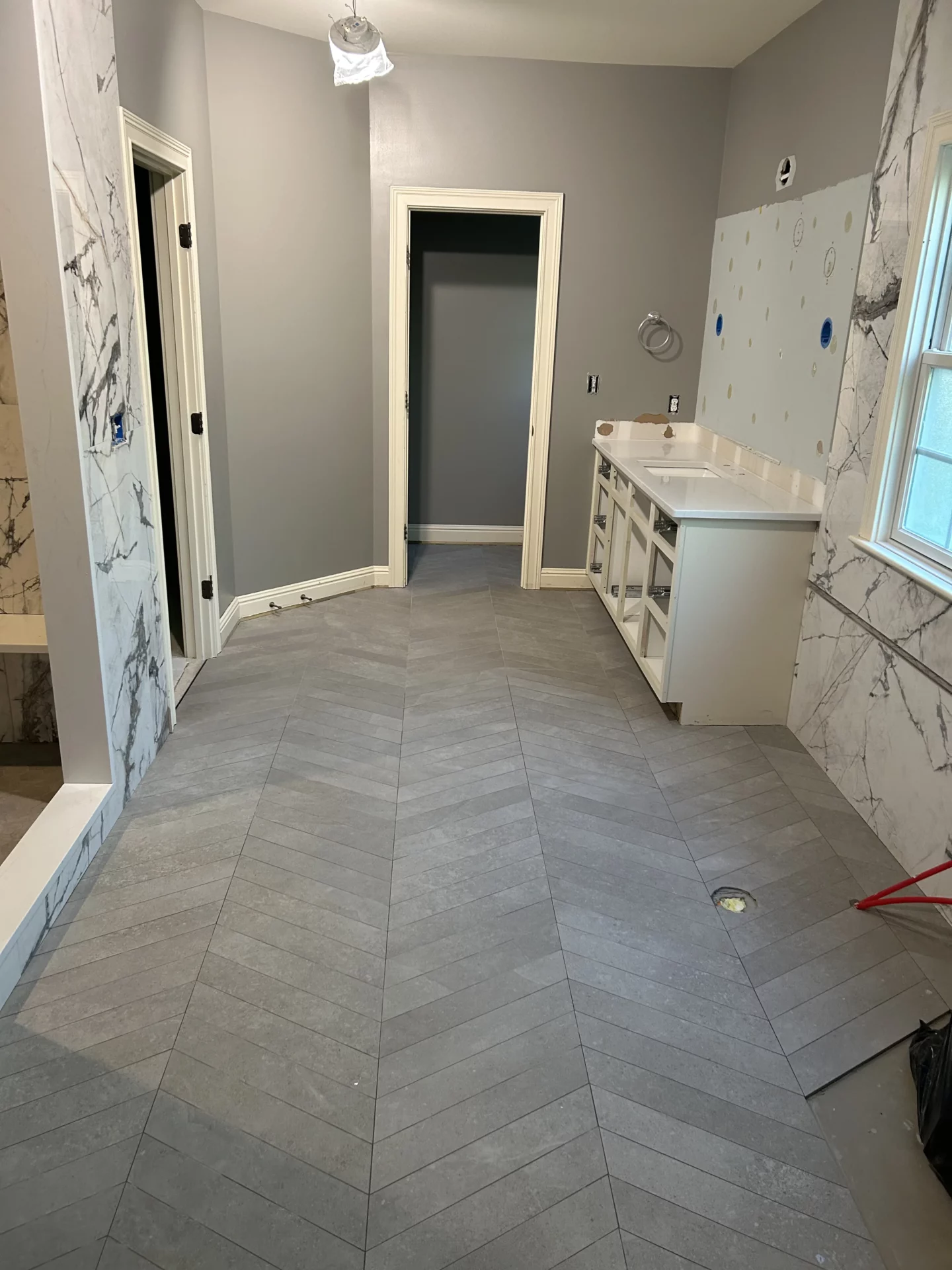 Elite Floors installer measuring and preparing a basement floor in Nicholasville, Kentucky